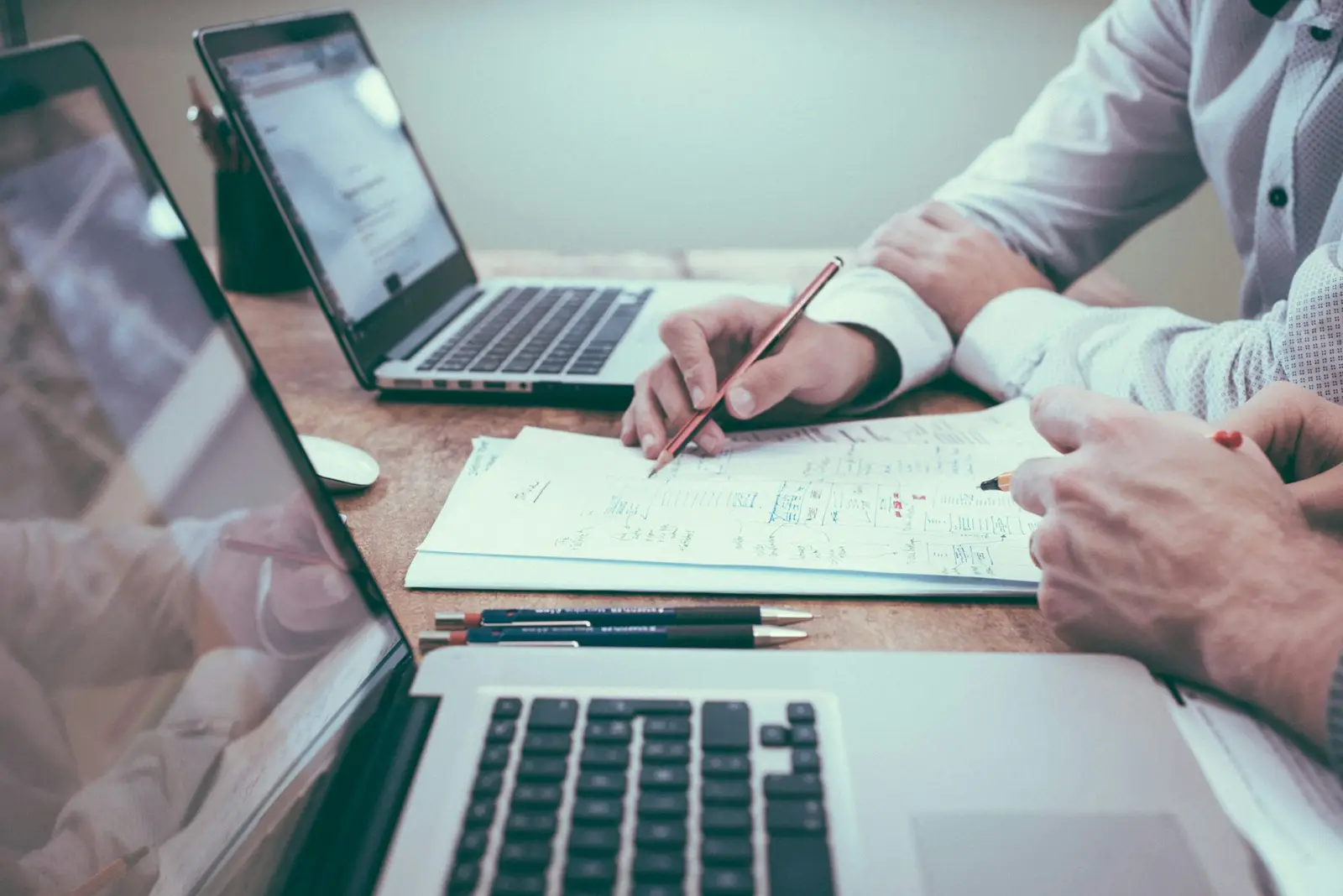 Two advisors reviewing documents at a desk
